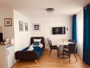 a bedroom with a bed and a table with chairs at Metalowiec in Stalowa Wola