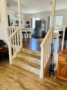 a staircase leading to a kitchen and a living room at Amazing River House in North Yunderup