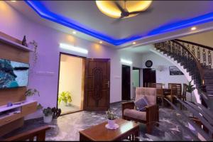 a living room with a blue led ceiling at Hosted by Resmi Jayalal in Cochin