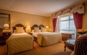 Ένα ή περισσότερα κρεβάτια σε δωμάτιο στο Granville Hotel