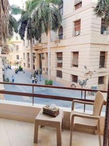 a balcony with a table and a chair and a building at Cairo City in Cairo