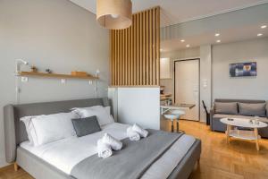 a bedroom with a large bed and a living room at The HostMaster Vista Loft in Athens