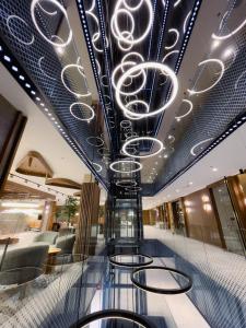 a lobby with a chandelier on the ceiling at Hotel Vema in Visoko