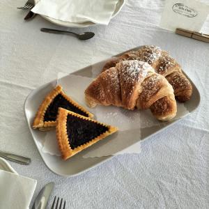 a plate with two slices of bread and a piece of cake at Stella d'Italia in Sparone