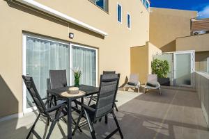 a patio with a table and chairs on a balcony at BAL Apartments Adults Only in Arona