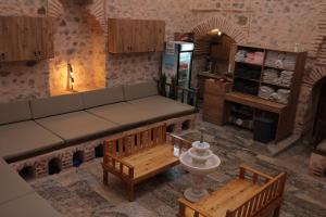 a living room with a couch and wooden benches at Ziyagil Konağı in Amasya
