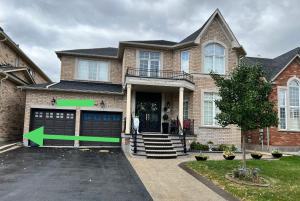 a house with a green arrow pointing to a garage at Tosam Luxury Lodge Two Bedroom Suite in Brampton
