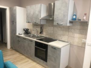 a small kitchen with a sink and a stove at Sweet home in Isnello