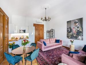 salon z różową kanapą i stołem w obiekcie Apartamenty Strzelecka 34 w Poznaniu