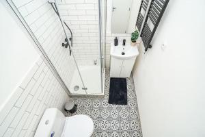 a bathroom with a toilet and a sink at Cozy apartment in hipster area in Prague