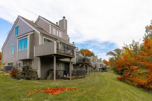 a large house with balconies and a yard at Fall Specials! Cozy King Beds, Pool Access, Galena Territory Amenities, Fireplace, Great Location in Galena Territory on Lake Galena in Galena
