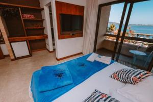a bedroom with a bed with a view of the ocean at Partner Itapoa by Marina in Itapoa