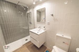 a bathroom with a sink and a shower and a toilet at Castilla Luxury 1B Apartment in Madrid