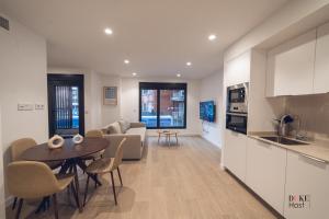 a kitchen and living room with a table and a couch at Castilla Luxury 1B Apartment in Madrid