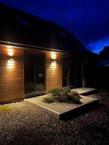 a house with lights on the side of it at night at Luxury stay Kings Annexe 5 minutes from Longleat in Warminster