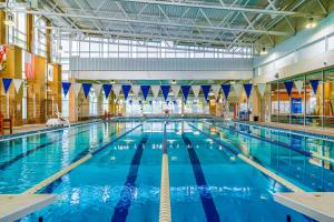 a large indoor swimming pool with blue water at Tall Oaks Retreat in McHenry