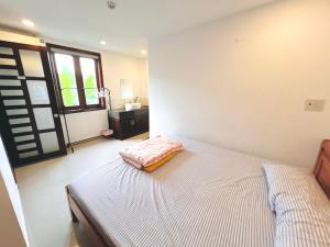 Ein Bett oder Betten in einem Zimmer der Unterkunft KENPI Homestay