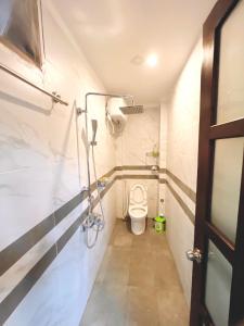 a bathroom with a toilet in a room at Homestay KENPI in Hue