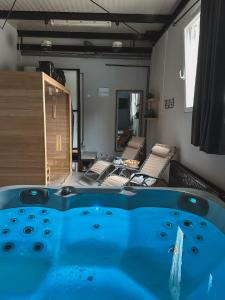 a bath tub in a room with a mirror at XXL rooms&spa in Osijek