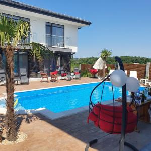 a villa with a swimming pool and a house at Capitan Niko Apartments in Burgas City