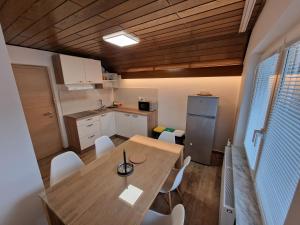 a kitchen and dining room with a table and chairs at Apartments Boldin in Bled