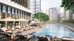 a rendering of a hotel pool with chairs and umbrellas at Hilton Garden Inn Dubai Business Bay in Dubai
