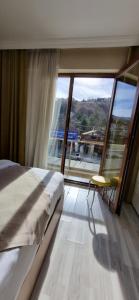 a bedroom with a bed and a large window at WİND HOTEL in Sakarya