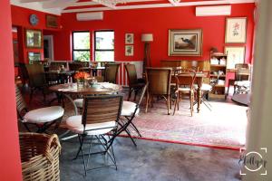 a restaurant with red walls and tables and chairs at Harrington House in Hilton