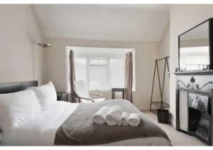 a bedroom with a bed with two towels on it at Chic 4BR Home in Mitcham Ideal for Families in Mitcham
