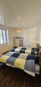 a bedroom with two beds and a chandelier at Maison de village in Sadroc