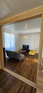 a view of a living room with a bed and a couch at Maison de village in Sadroc