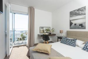 a bedroom with a bed and a view of the ocean at Villa Arausa in Vodice