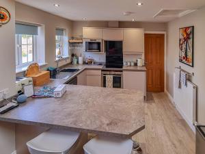 a kitchen with a large marble counter top and appliances at Duck Cottage in Tholthorpe