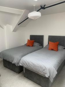 two beds sitting next to each other in a bedroom at Stylish apartment in the centre of Hebden Bridge. in Hebden Bridge