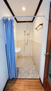 a bathroom with a shower with a tub and a sink at Khaosok River Camp in Khao Sok National Park