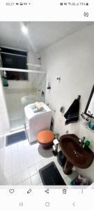 a small bathroom with a toilet and a sink at Apartamento Barra in Salvador