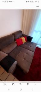 a brown couch with colorful pillows in a living room at Apartamento Barra in Salvador