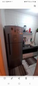 a kitchen with a stainless steel refrigerator and a sink at Apartamento Barra in Salvador