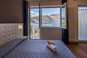 a bedroom with a bed with a view of the ocean at Hotel Al Molino in Malcesine