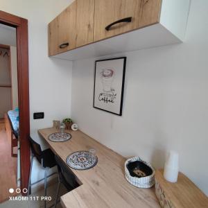 a kitchen with a wooden counter top in a room at La Casetta Mini Appartamento Centro Storico in Reggio di Calabria