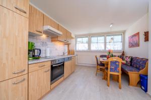 a kitchen and dining room with a table and a couch at Fewo Steiner in Tröpolach