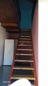 a staircase in a room with a white refrigerator at Casa quinta con pileta in Santa Rosa