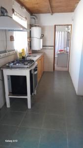 a kitchen with a stove top oven in a room at Casa quinta con pileta in Santa Rosa