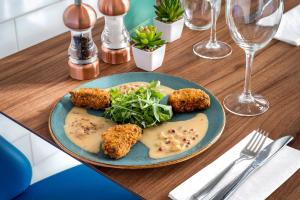 a table with a plate of food on a table at Courtyard by Marriott Glasgow Airport in Paisley