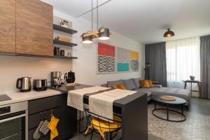 a kitchen and a living room with a couch at Contemporary Charm in Old Sofia in Sofia