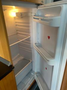 an empty refrigerator with its door open and a heart on it at IRIS ROOM in Monopoli