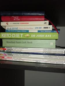 a stack of books sitting on top of a table at 59 Halstead - Gorgeous single bedroom with private bathroom in Halstead