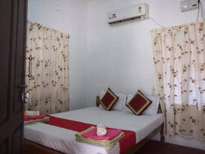 Un ou plusieurs lits dans un hébergement de l'établissement Leena marari beach house