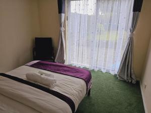 a bedroom with a bed with two towels on it at Haven Home in Bristol