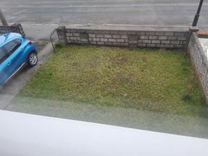 a blue car parked in front of a yard at Haven Home in Bristol